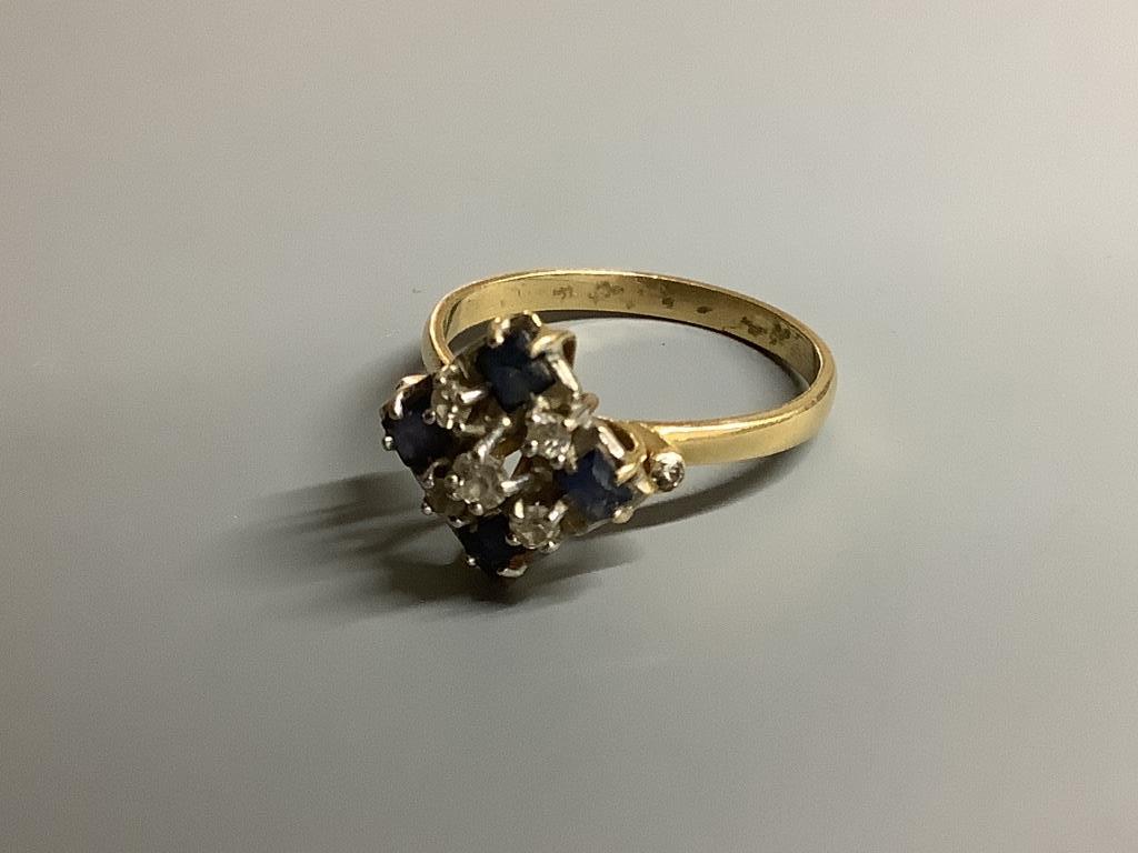 An 18ct, sapphire and diamond cluster ring, size N, gross 3.1 g.